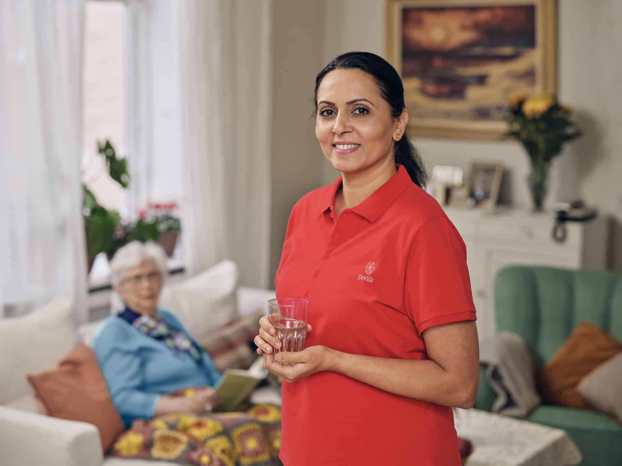 Caregiver gets a drink of water for her client
